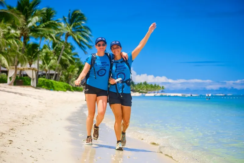 two-women-crossing-a-beach-during-femina-adventure-mauritius--an-empowering-outdoor-challenge-for-women-who-love-adventure-travel..webp