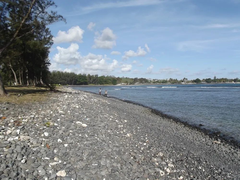 Pebble-covered shoreline at Rivière des Galets on the south coast of Mauritius.