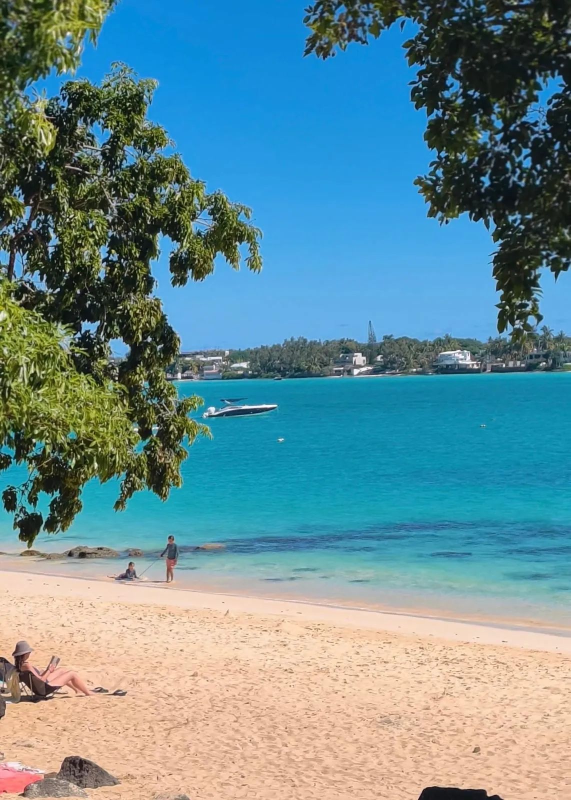 Scenic La Cuvette Beach framed by coastal rocks in Grand Baie, northern Mauritius.