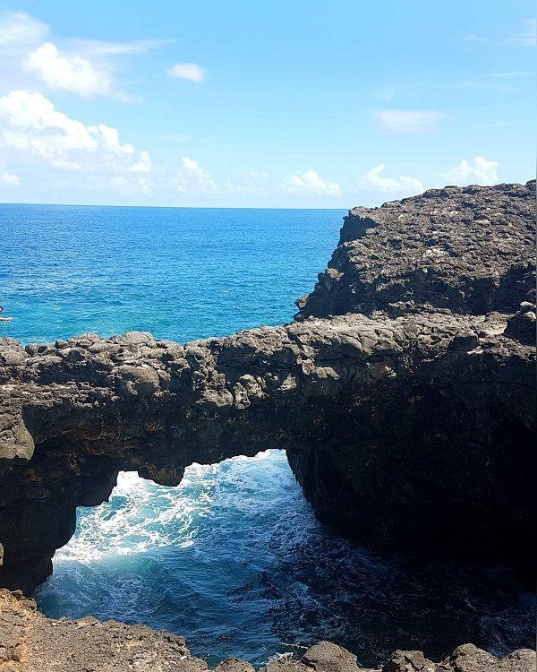 Natural Bridge Mauritius, also known as Pont Naturel, a dramatic volcanic rock formation on the wild south-east coast.