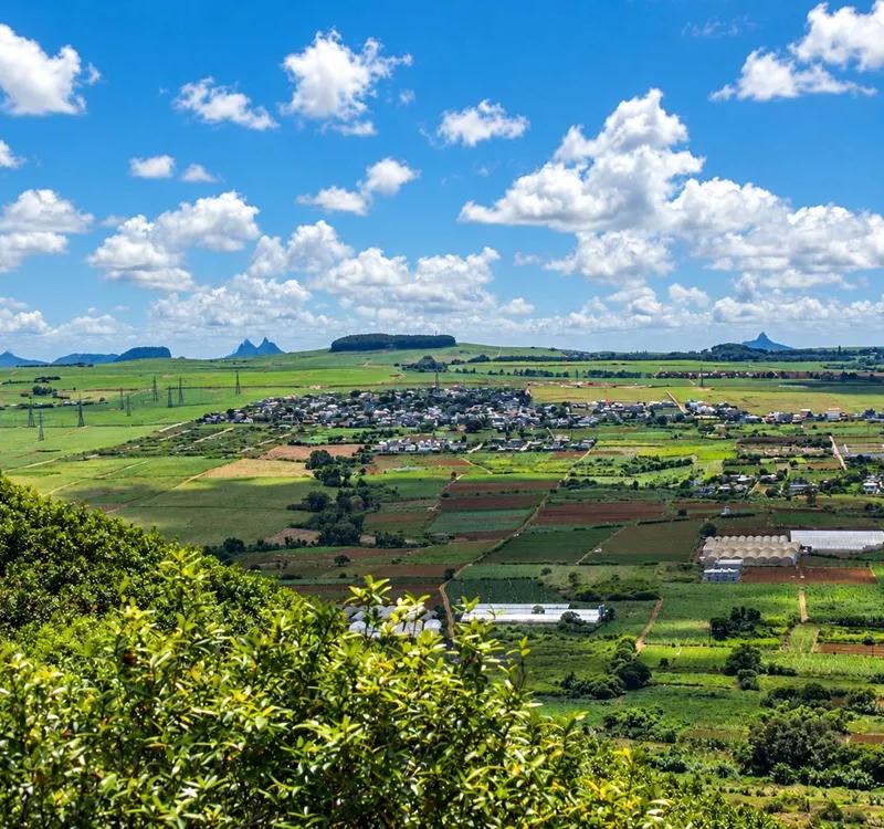 panoramic-valley-fields-and-village.webp