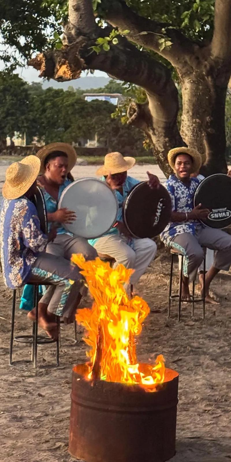traditional-sega-show-on-a-mauritius-beach-at-sunset-with-dancers-in-turquoise-costumes--live-drums--golden-sand-and-warm-tropical-evening-light..webp